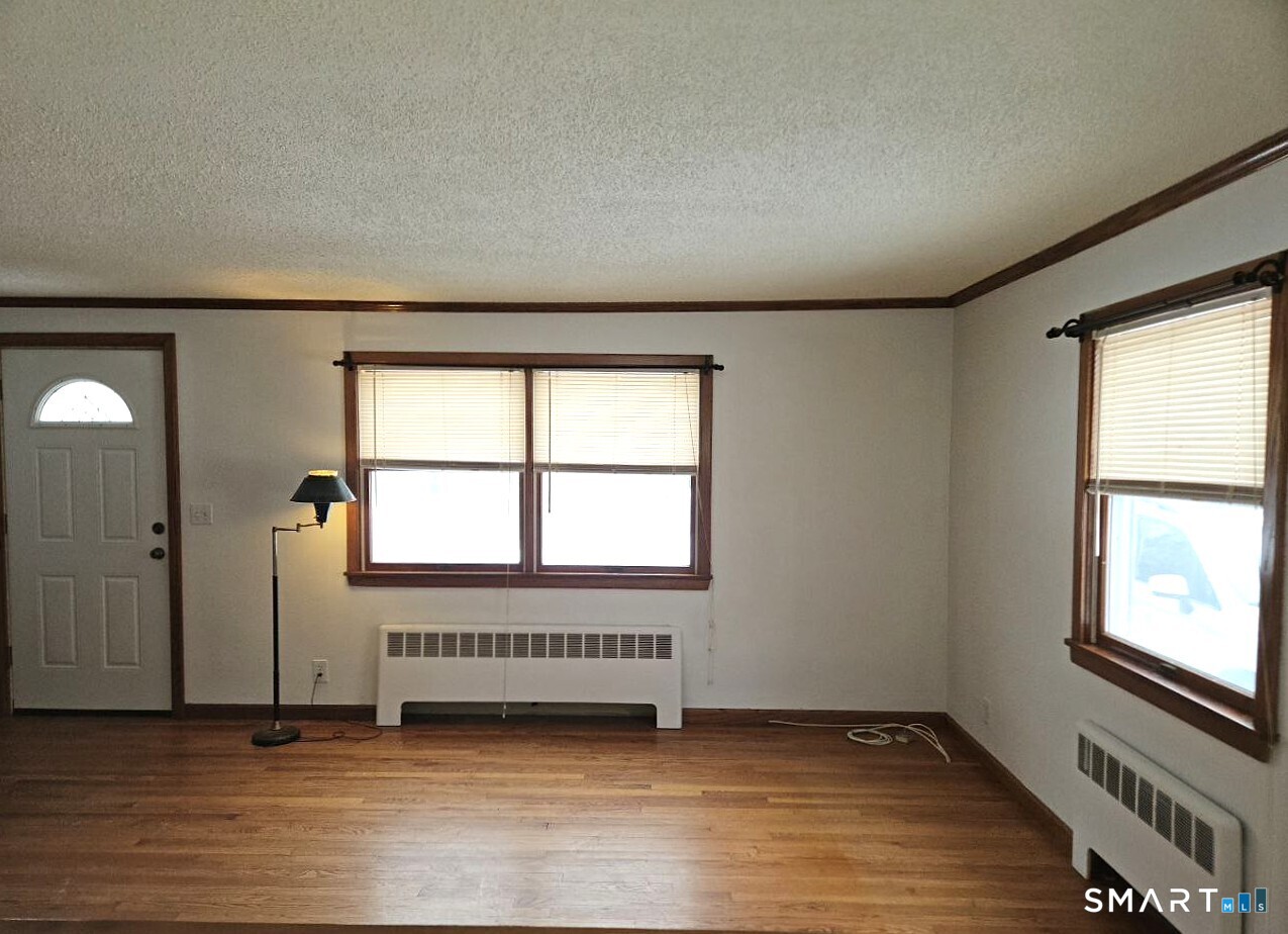 35 Lardner Road Bristol, CT 06010 - Photo 10 of 40 an empty room with wooden floor and windows