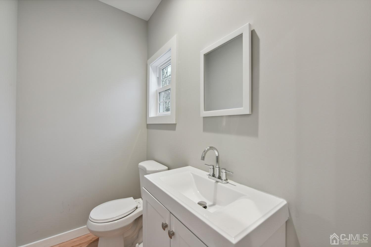 13 Albany Street Edison, NJ 08837 - Photo 13 of 26 a bathroom with a sink mirror and toilet