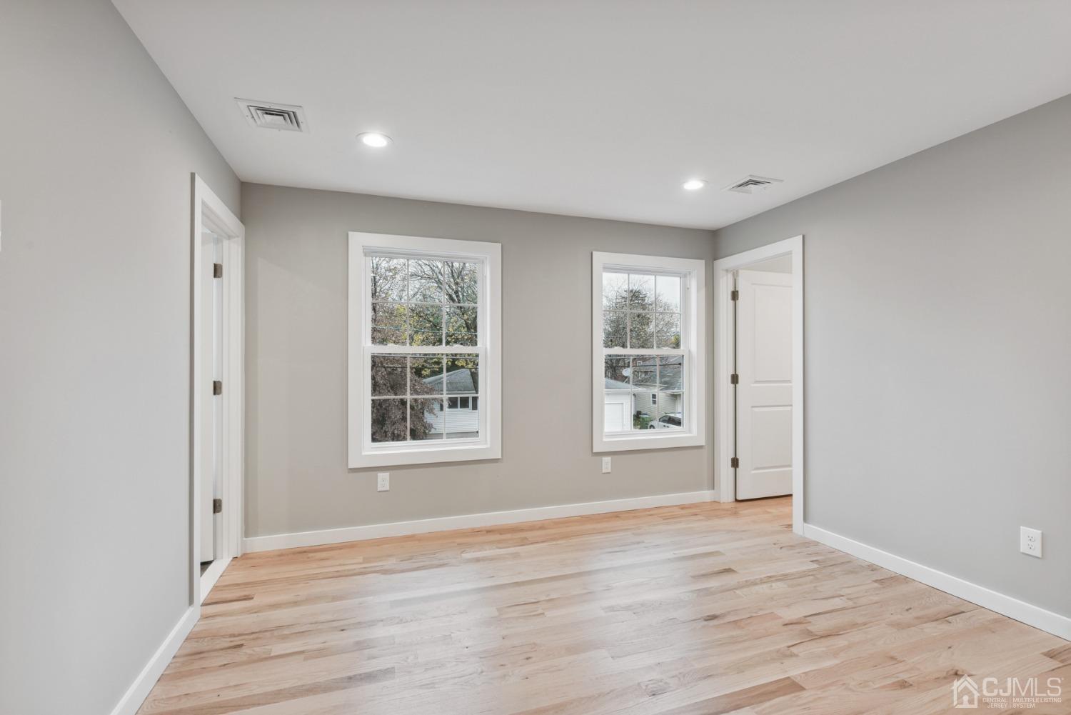 13 Albany Street Edison, NJ 08837 - Photo 17 of 26 a view of empty room with wooden floor and fan