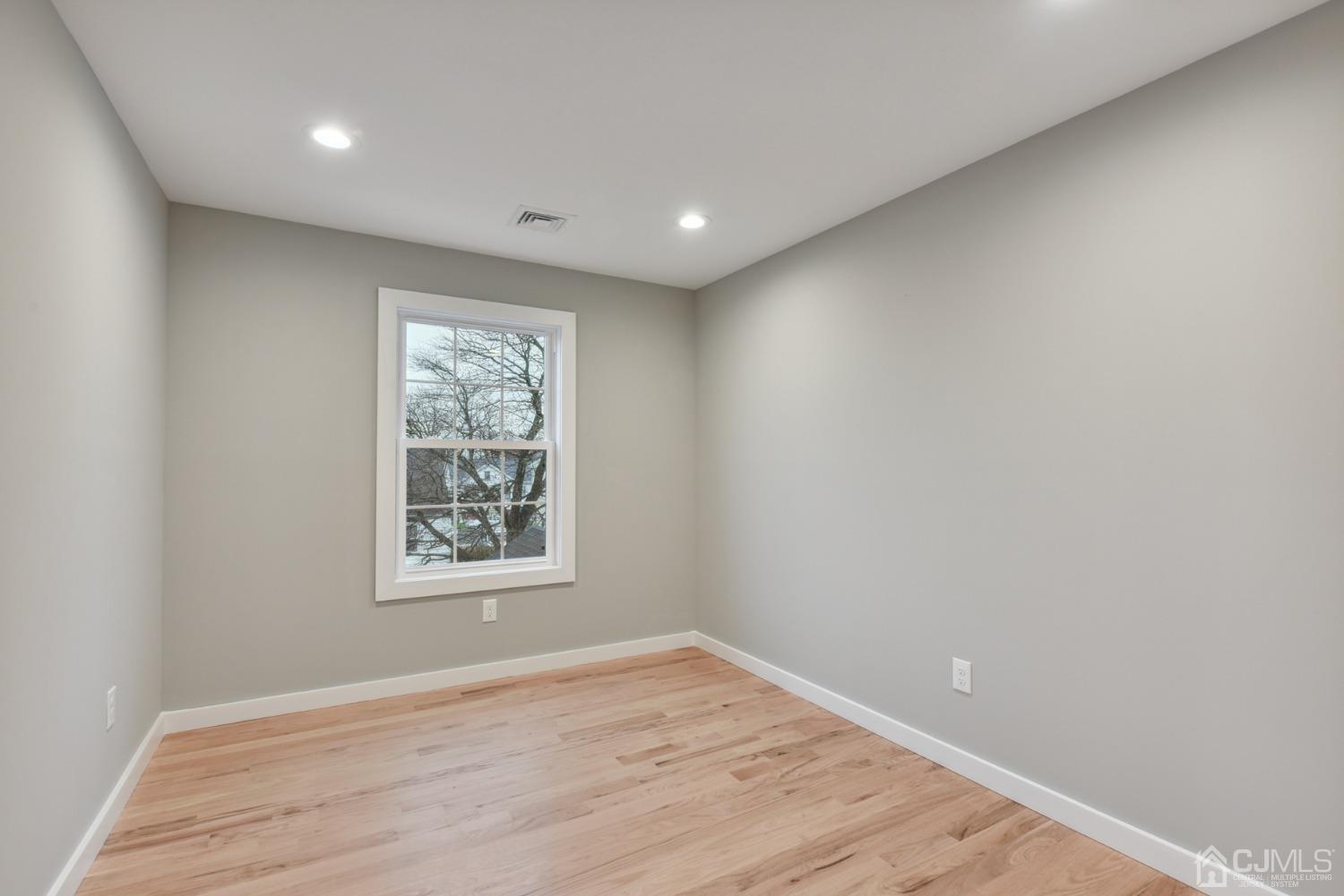 13 Albany Street Edison, NJ 08837 - Photo 20 of 26 a view of empty room with wooden floor and fan