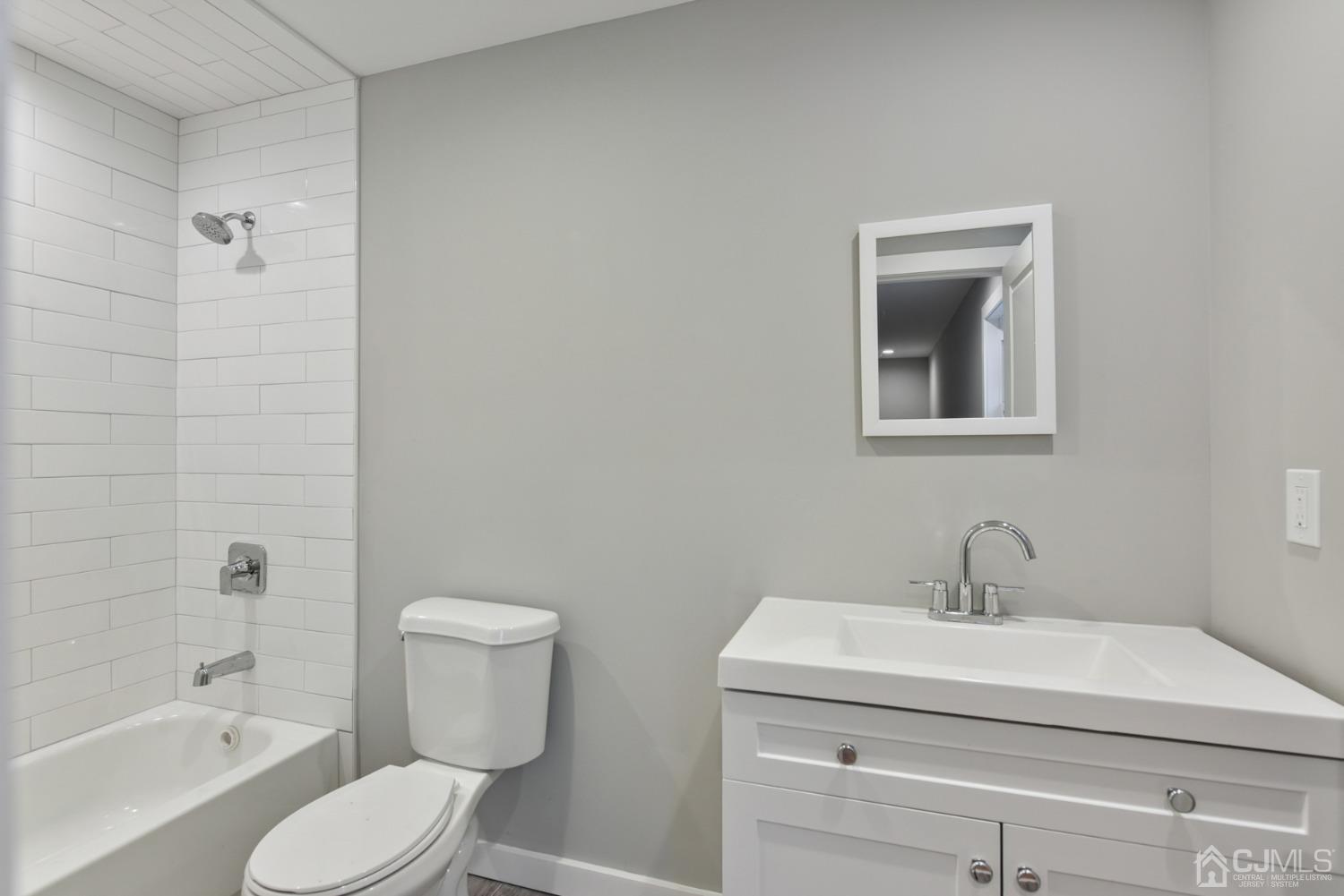 13 Albany Street Edison, NJ 08837 - Photo 21 of 26 a bathroom with a toilet a sink and bathtub