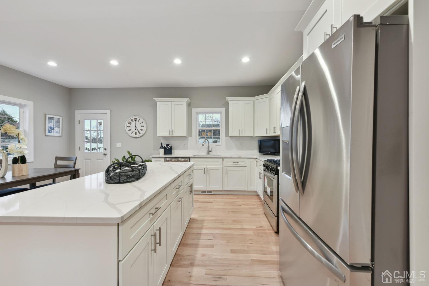 13 Albany Street Edison, NJ 08837 - Photo 10 of 26 a kitchen with white cabinets and refrigerator