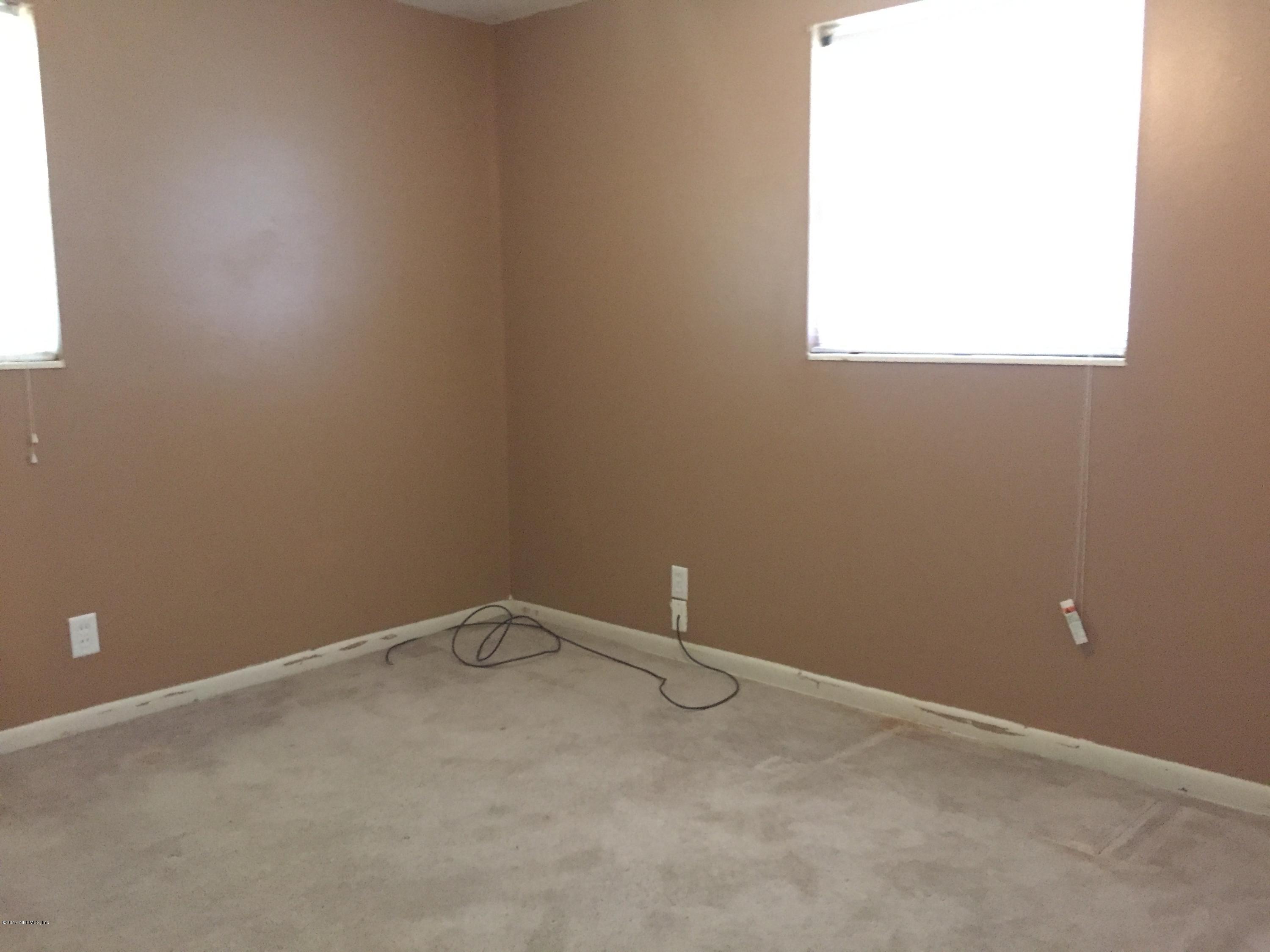 5838 Ensenada Road Jacksonville, FL 32244 - Photo 16 of 23 an empty room with a window