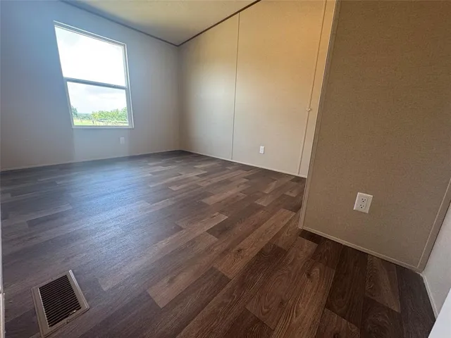 a view of walk in closet with wooden floor