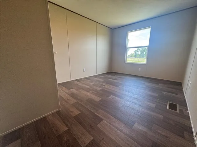 a bathroom with a granite countertop sink toilet and mirror