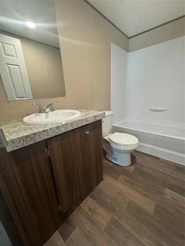 a bathroom with a bathtub and a toilet