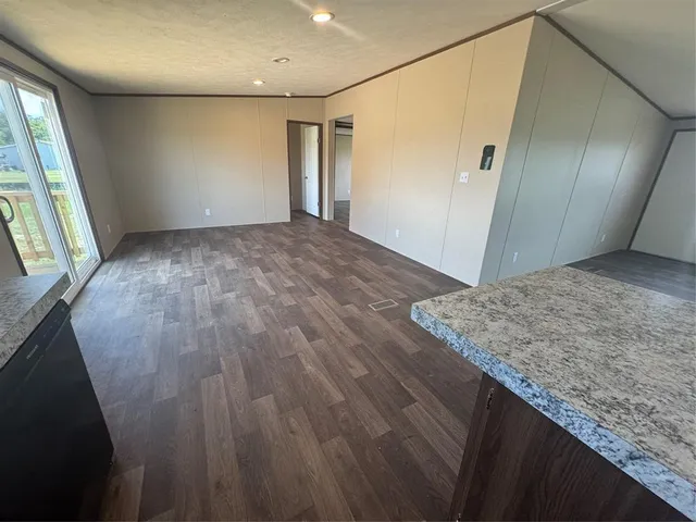 a view of a room with wooden floor