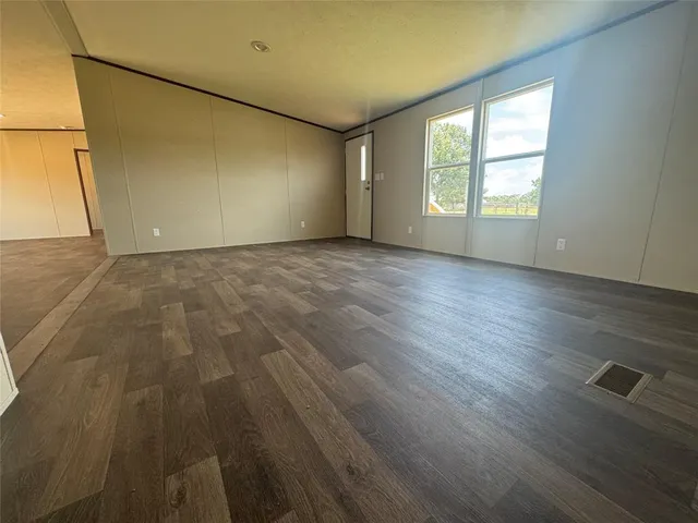 a bathroom with a granite countertop sink toilet and a mirror