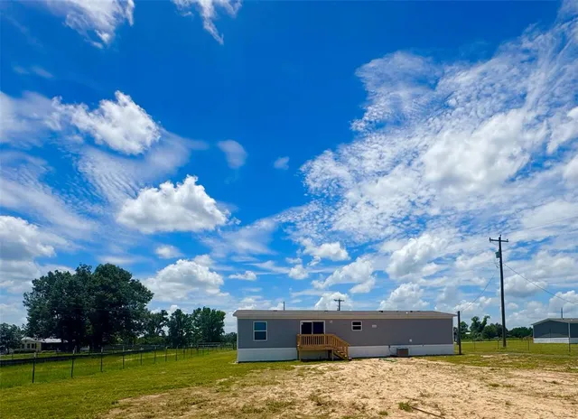 a backyard of a house with lots of green space