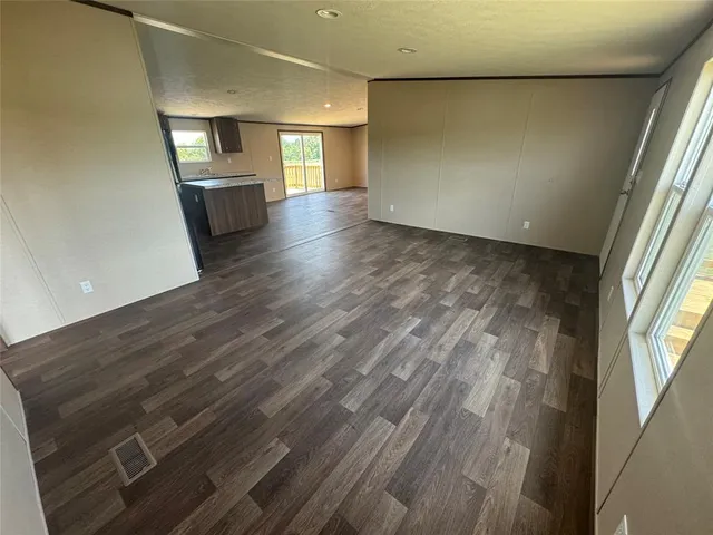 a kitchen with stainless steel appliances granite countertop a refrigerator a sink a stove and oven