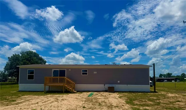 a backyard of a house with barbeque oven