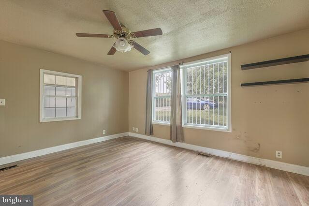 7401 Watersville Road Mount Airy, MD 21771 - Photo 3 of 26 a view of an empty room with a window and wooden floor