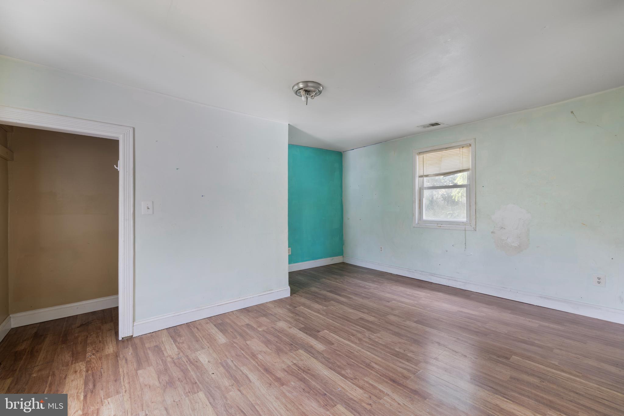 7401 Watersville Road Mount Airy, MD 21771 - Photo 8 of 26 an empty room with wooden floor and windows