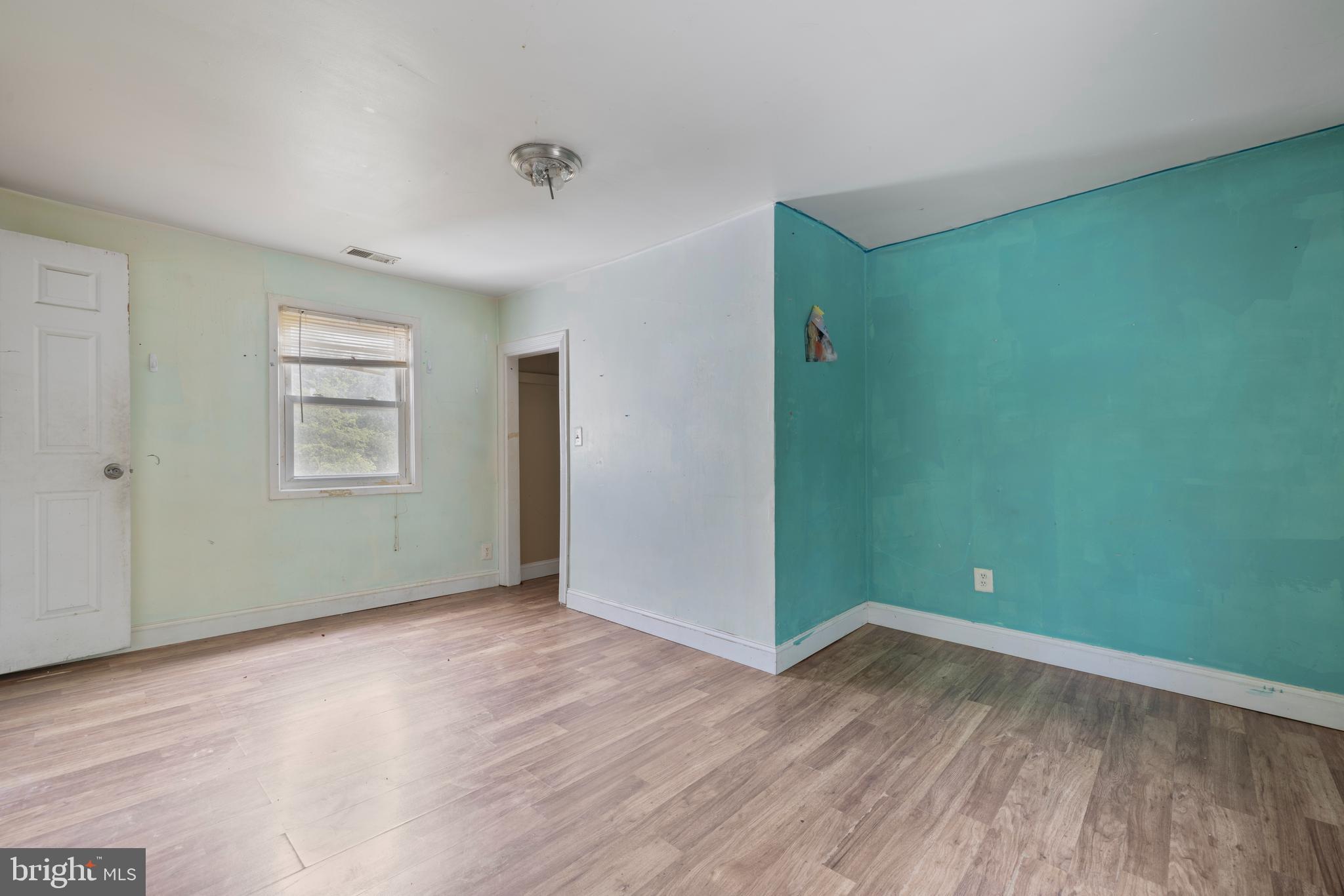 7401 Watersville Road Mount Airy, MD 21771 - Photo 9 of 26 an empty room with wooden floor and windows