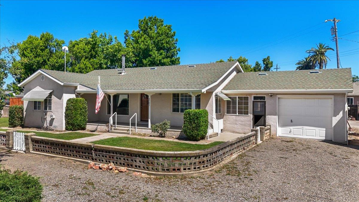 4701 Lone Tree Road Valley Home, CA 95361 - Photo 1 of 59 a front view of house with a garden and patio