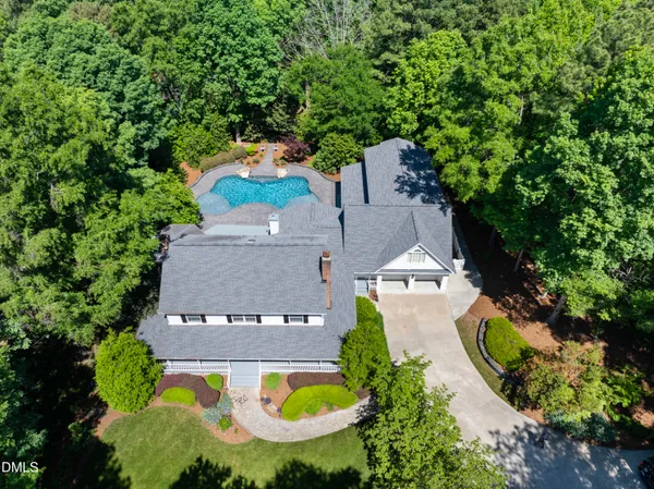 an aerial view of a house with swimming pool and garden space