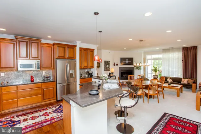 a living room with furniture a rug and a flat screen tv
