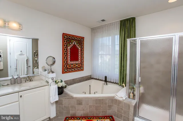 a white bath tub sitting next to a window