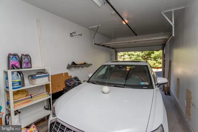a front view of a building with large trees