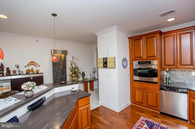 a kitchen with stainless steel appliances granite countertop a refrigerator and a sink
