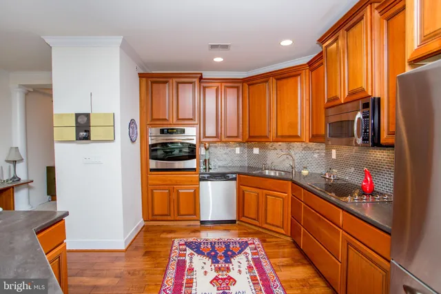a kitchen with stainless steel appliances granite countertop a sink and cabinets