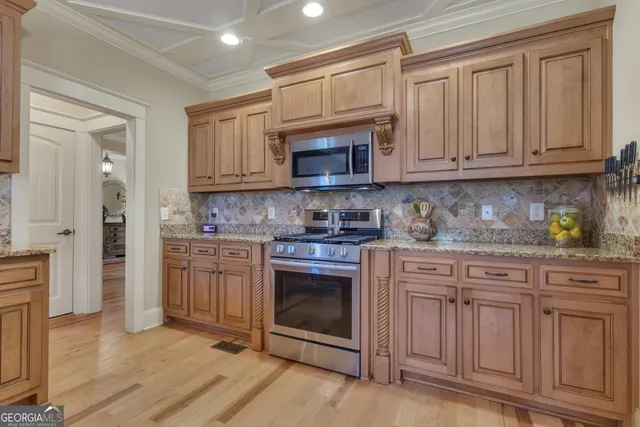 a bathroom with a granite countertop sink a toilet and shower