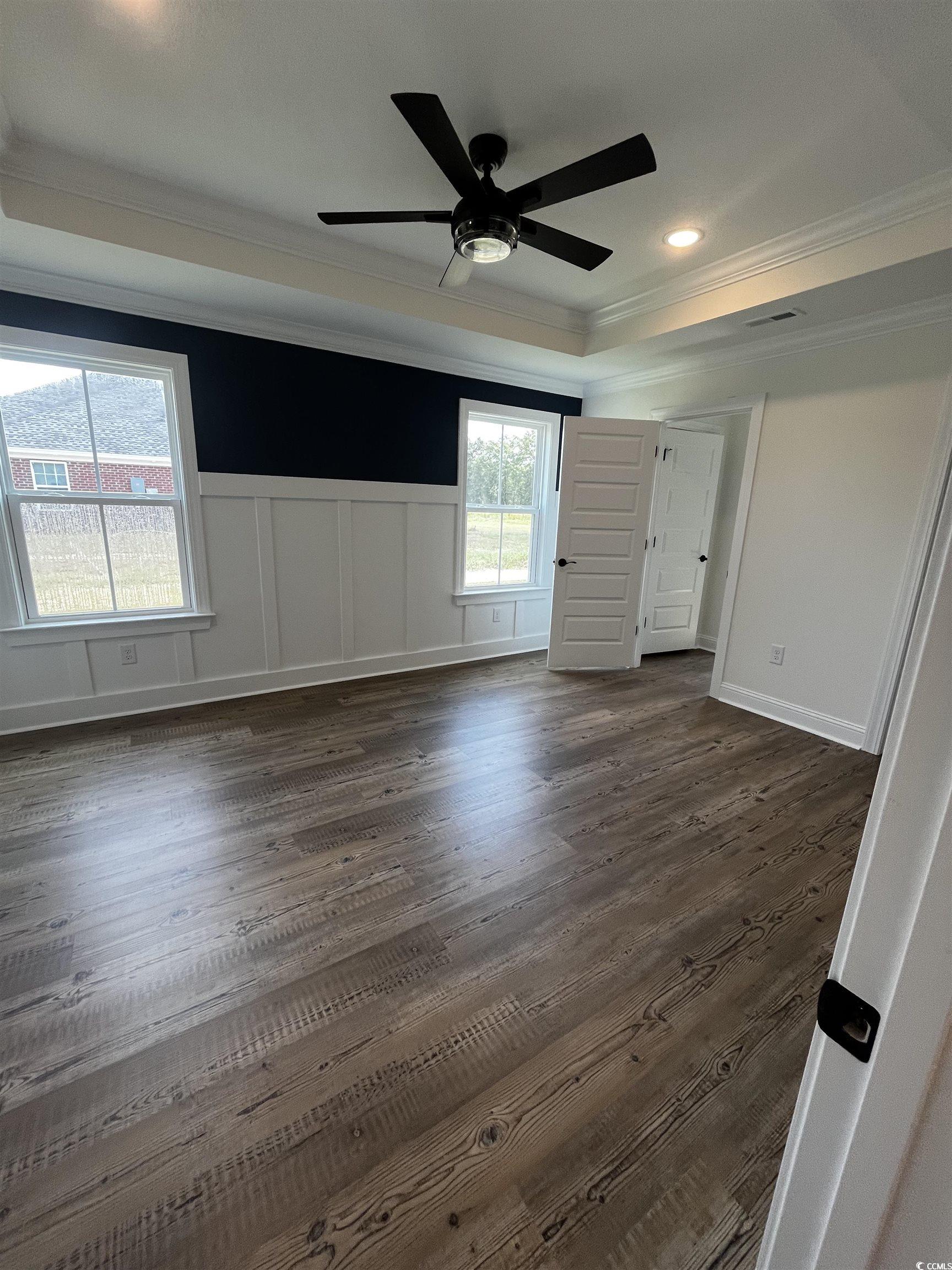 3420 Asbury Road Aynor, SC 29511 - Photo 7 of 8 Unfurnished bedroom featuring ornamental molding, dark wood finished floors, recessed lighting, ceiling fan, and a tray ceiling