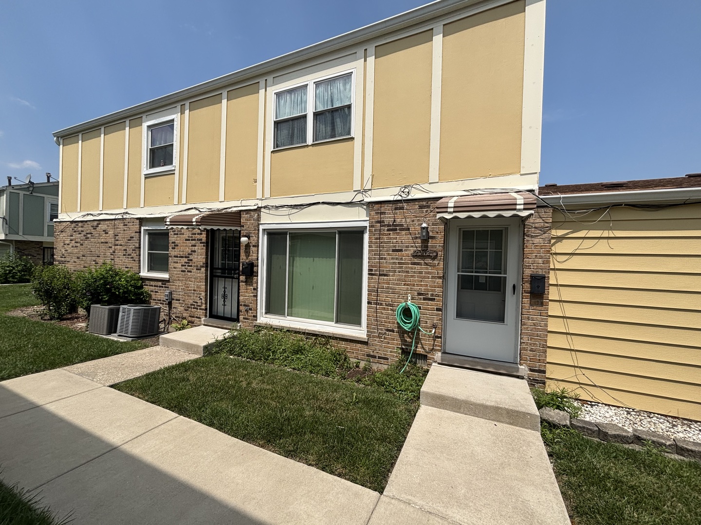 20124 Oak Lane Lynwood, IL 60411 - Photo 1 of 19 a front view of a house with a yard