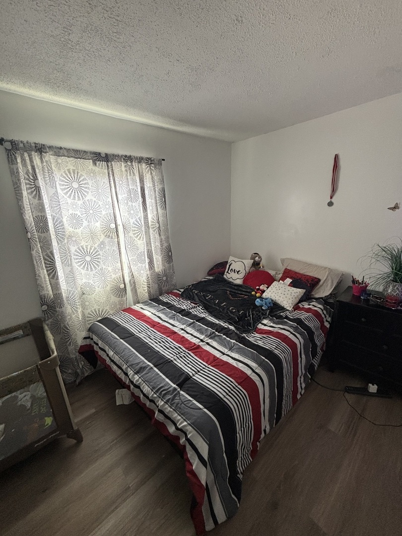 20124 Oak Lane Lynwood, IL 60411 - Photo 15 of 19 a bed sitting in a bedroom next to a window