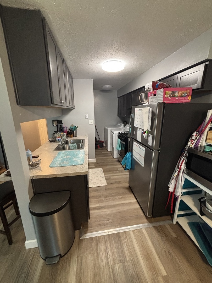 20124 Oak Lane Lynwood, IL 60411 - Photo 8 of 19 a room with wooden floor a table and chairs