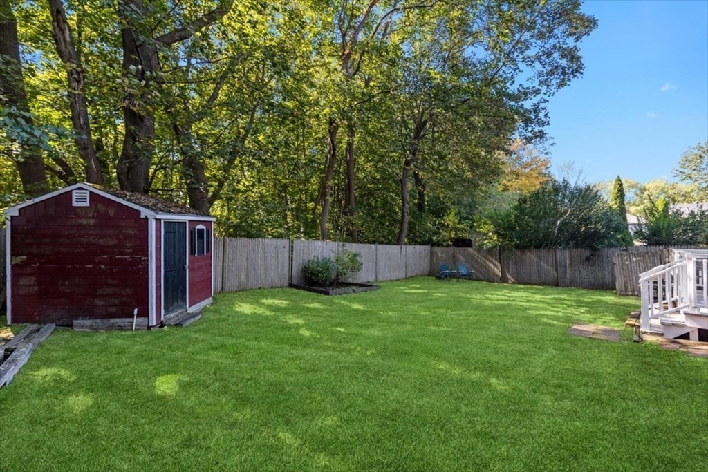 11 Sanborn Road Hingham, MA 02043 - Photo 26 of 33 a backyard of a house with lots of plants and tree