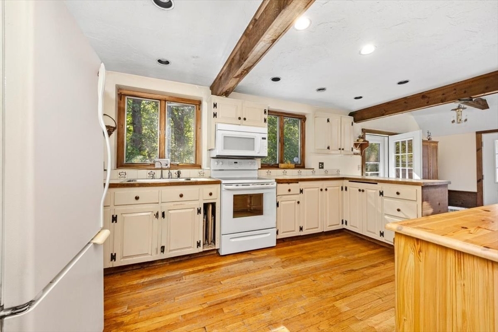 11 Sanborn Road Hingham, MA 02043 - Photo 6 of 33 a kitchen with a stove a sink and a refrigerator