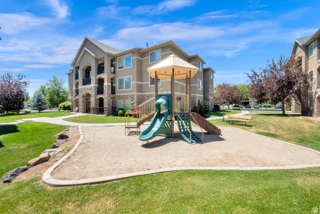 909 South Main Street, Unit G Layton, UT 84041 - Photo 22 of 25 Outdoor playground area featuring a sand base and a multi-component play structure with slides