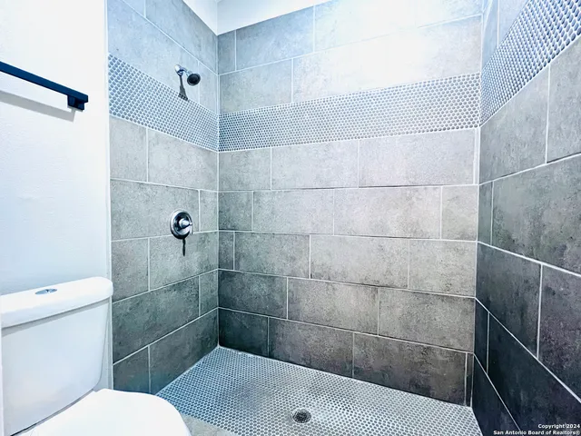 a bathroom with a toilet and shower