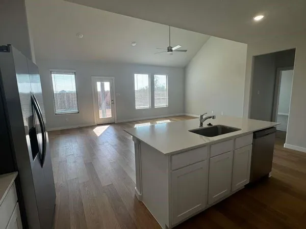 a kitchen with sink and mirror