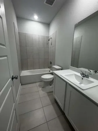 a bathroom with a double vanity sink toilet and shower