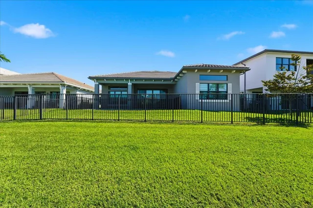 a view of a house with a backyard
