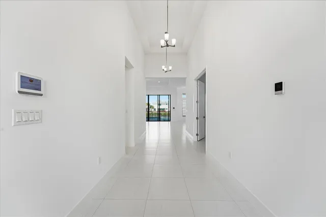 a view of a hallway with wooden floor and a bathroom