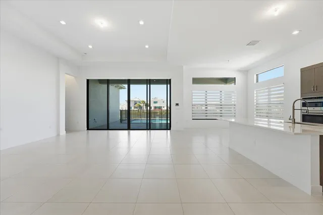a view of an empty room with a fireplace and a window