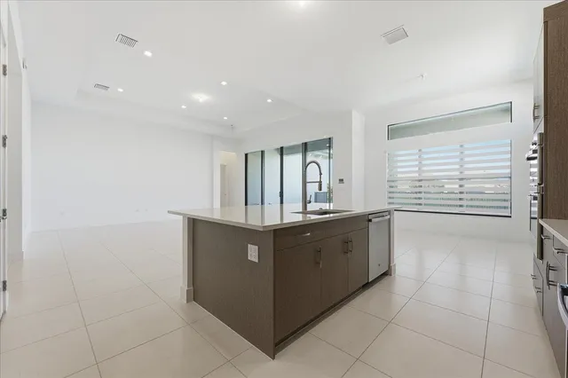 a large kitchen with granite countertop a sink