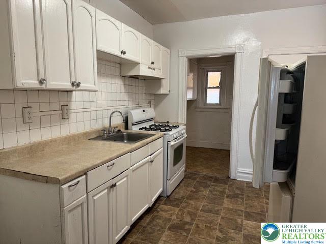 208 Ridge Avenue Allentown, PA 18102 - Photo 6 of 17 a kitchen with stainless steel appliances a sink stove and refrigerator
