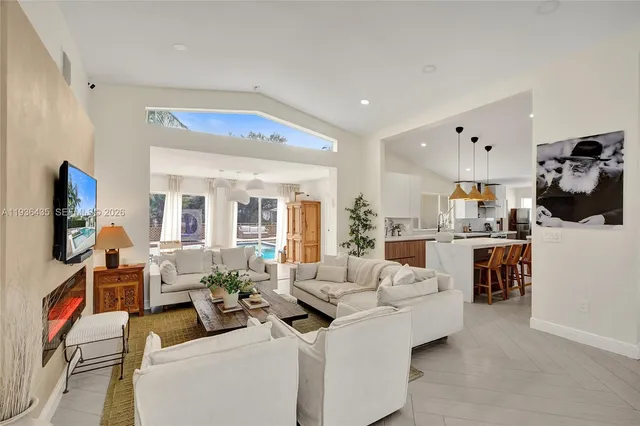 a view of a dining room with furniture and a chandelier