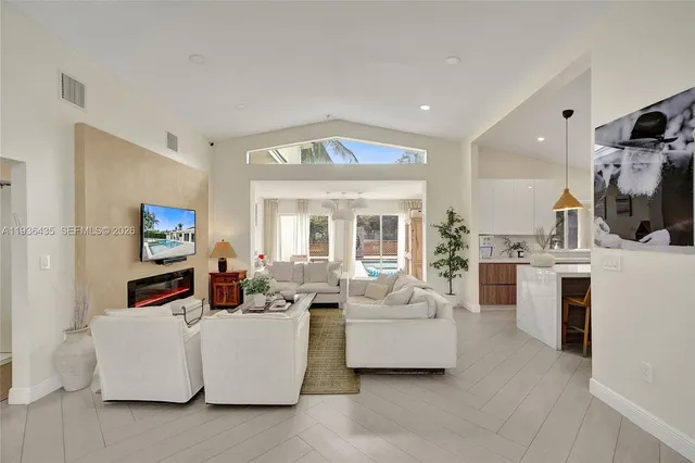 a bedroom with a bed and a flat tv screen on a dresser