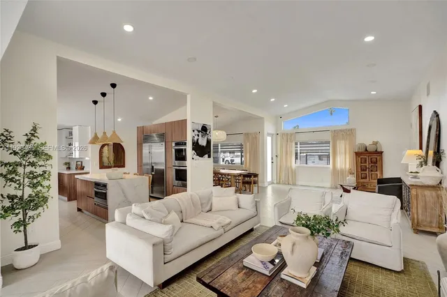 a bedroom with a bed a lamp and a large mirror