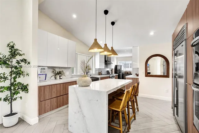 a view of a patio with a table and chairs under an umbrella
