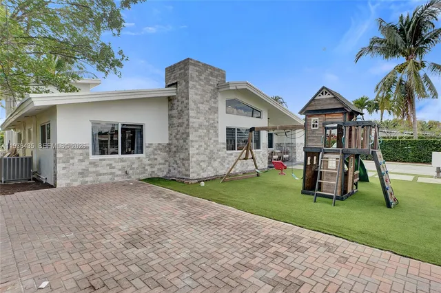 a living room with furniture kitchen view and a window