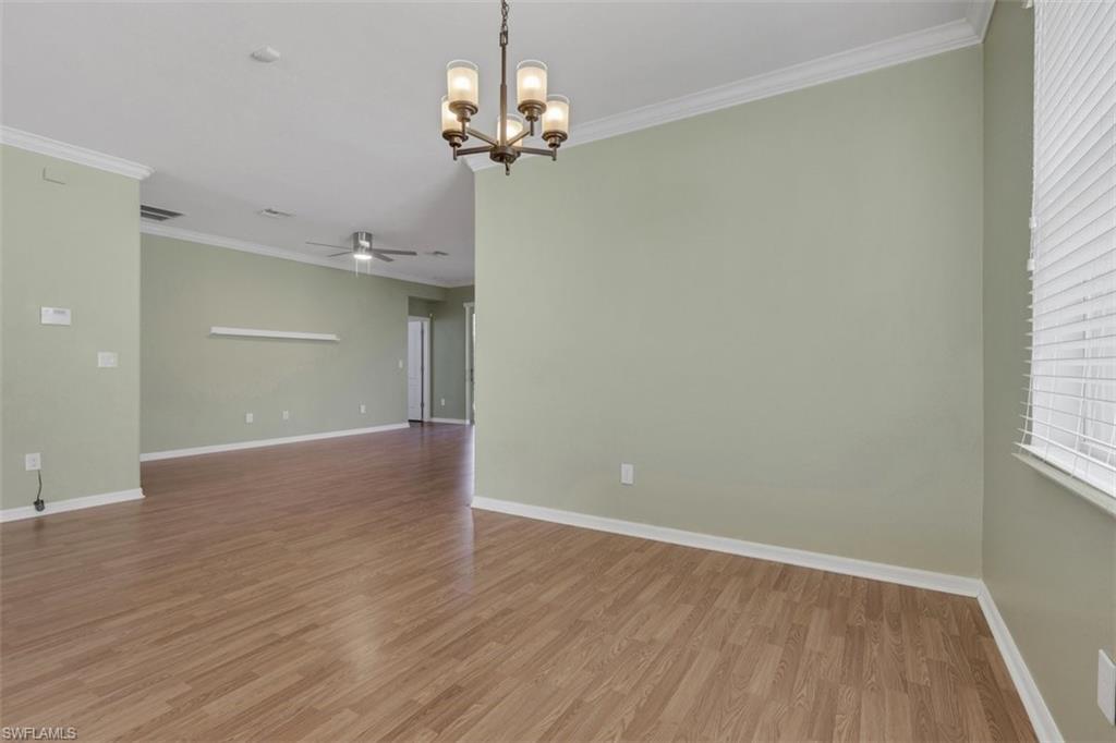 2391 Heydon Circle East Naples, FL 34120 - Photo 15 of 42 wooden floor in an empty room with a window