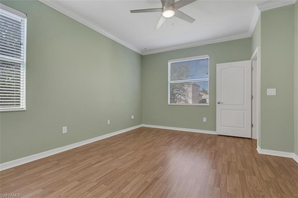 2391 Heydon Circle East Naples, FL 34120 - Photo 17 of 42 wooden floor in an empty room with a window