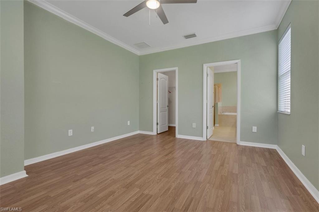 2391 Heydon Circle East Naples, FL 34120 - Photo 19 of 42 wooden floor in an empty room with a window