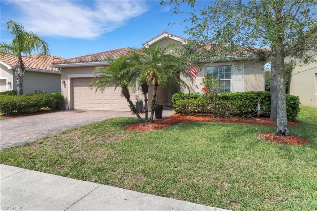 2391 Heydon Circle East Naples, FL 34120 - Photo 2 of 42 front view of a house with a yard
